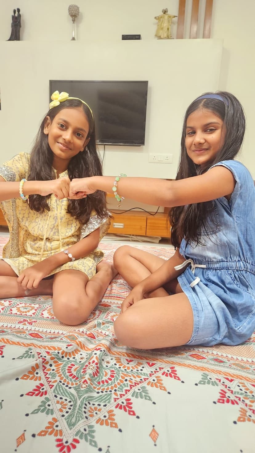 Khushi and friend making heart with hands