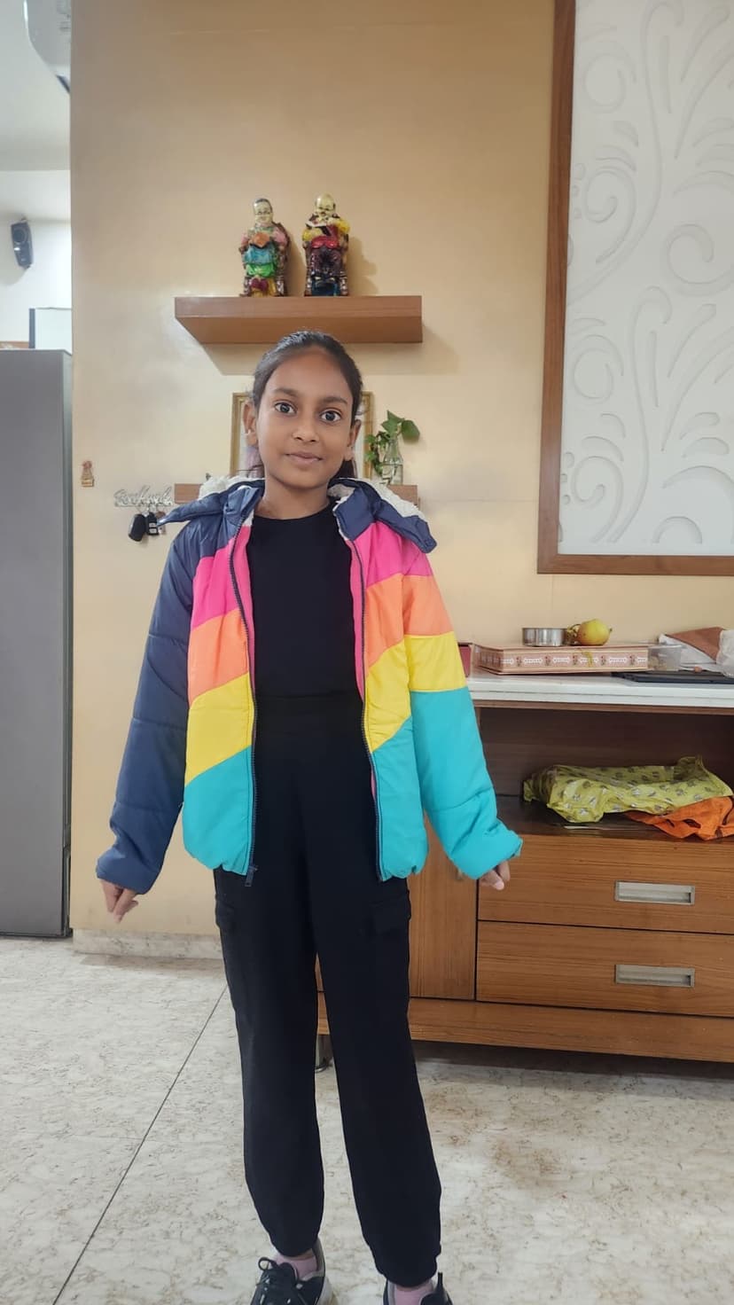 Khushi in colorful rainbow jacket