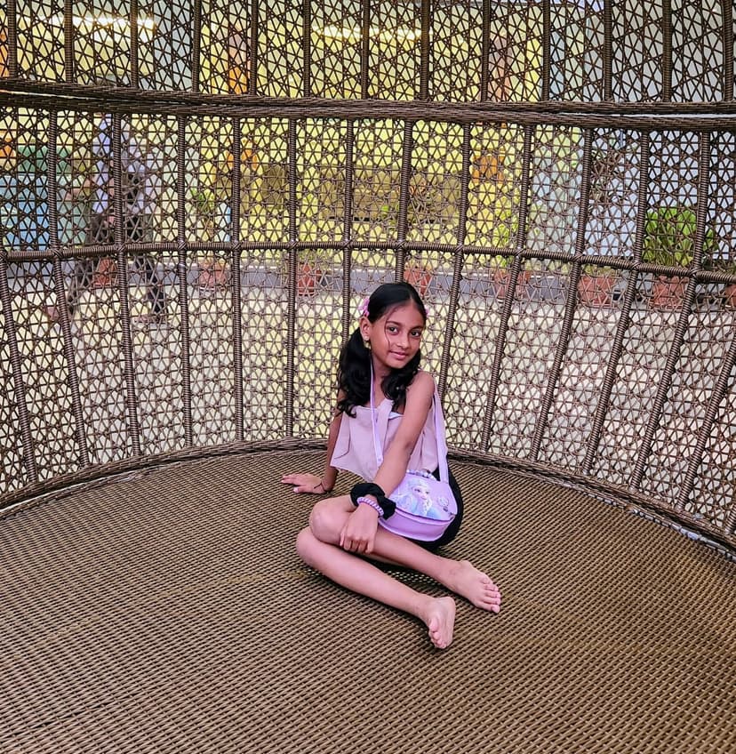 Khushi sitting in decorative swing